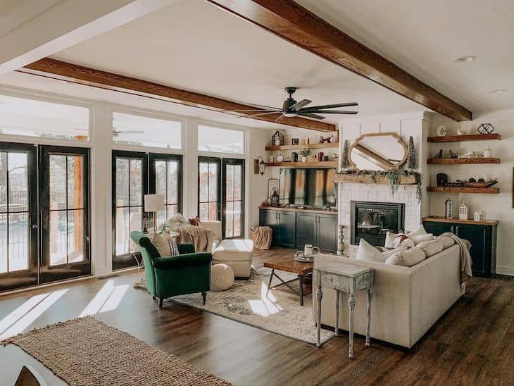 a living room filled with furniture and a fire place in the middle of an open floor plan