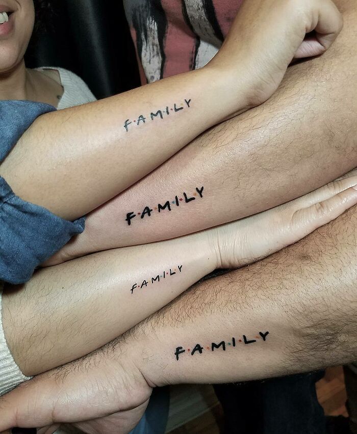 three people with matching tattoos on their legs are holding onto each other's arms