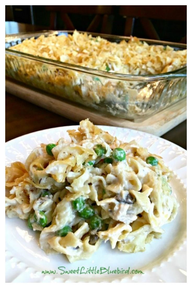 a white plate topped with pasta and peas next to a glass casserole dish