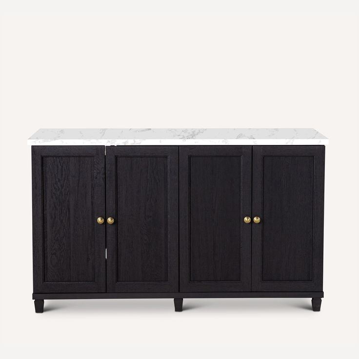 a black cabinet with marble top and brass handles