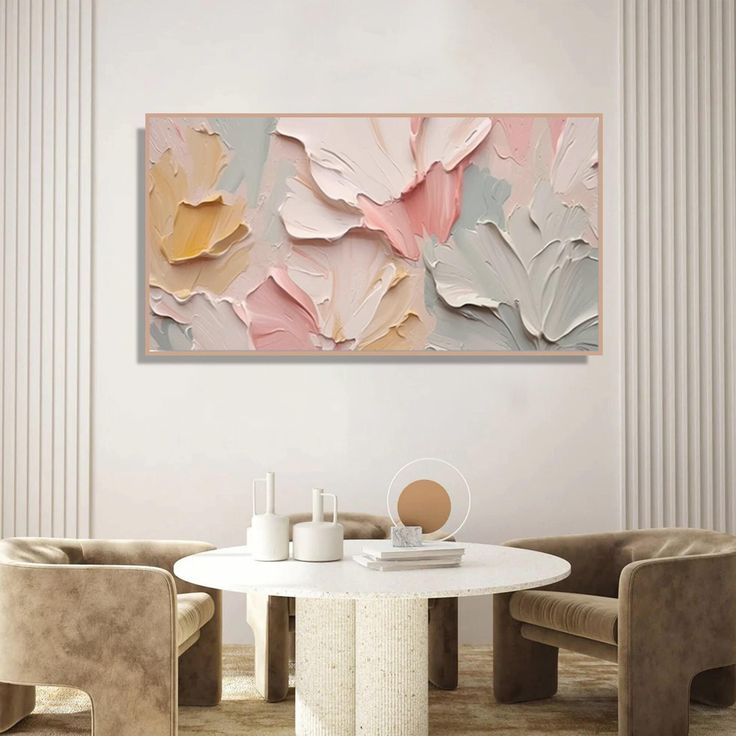 a white table with two chairs and a painting on the wall behind it in a living room