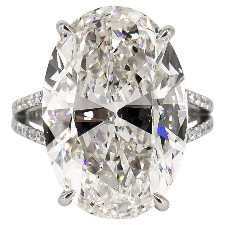 an oval cut diamond ring with pave set shoulders