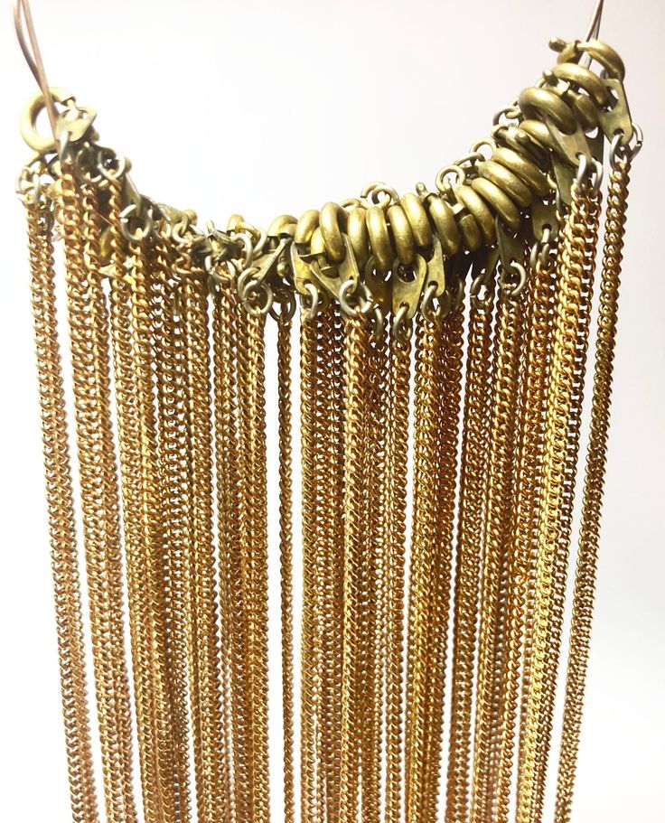 "Description: Gold Tone Vintage Fine Necklaces, Textured Cable Link Chains, finished with round brass clasps (spring ring) Measurements: 16\" long, chain width measures about 1/16th inch Quantity in Lot: 34 necklaces   This listing is for a lot of 34 delicate, gold-tone necklace chains that feature round brass clasps for closure. These supplies are are a bit tarnished, giving them a rustic and truly  Vintage look==and may show some signs of tarnishing but clean up easily. Costume Jewelry Finding Bronze Brass Chain Jewelry, Bronze Brass Jewelry With Chain, Bronze Adjustable Chain Necklace In Brass, Antique Gold Brass Chain Necklace With Adjustable Chain, Bronze Adjustable Chain Brass Necklace, Bronze Brass Chain Necklace With Adjustable Chain, Bronze Brass Adjustable Chain Necklace, Round Chain Necklace With Adjustable Chain, Brass Dangle Chain Necklaces