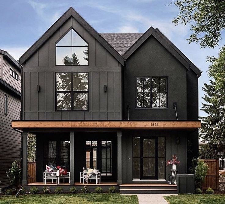 a large black house with lots of windows