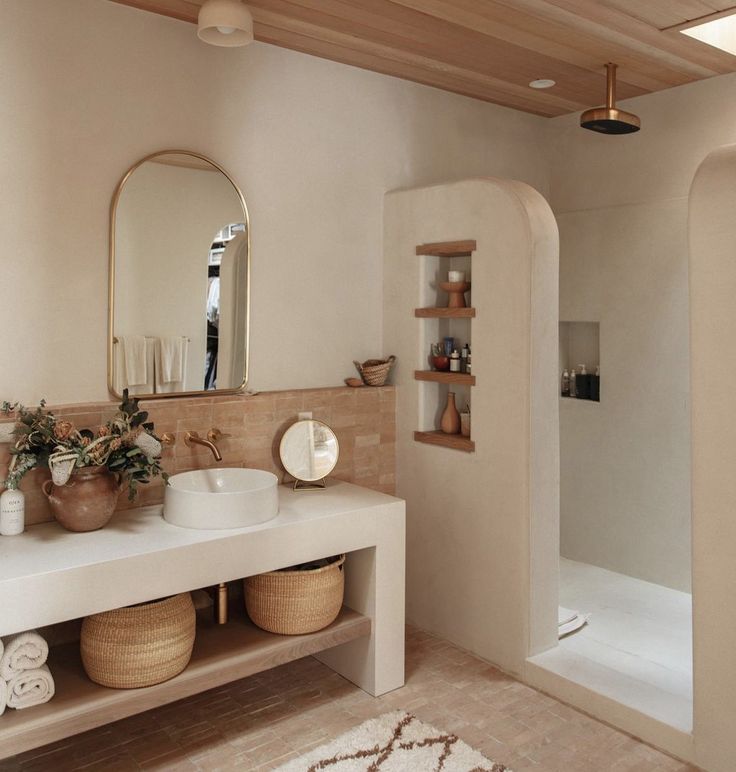 a bathroom with a sink, mirror and bathtub next to a walk in shower