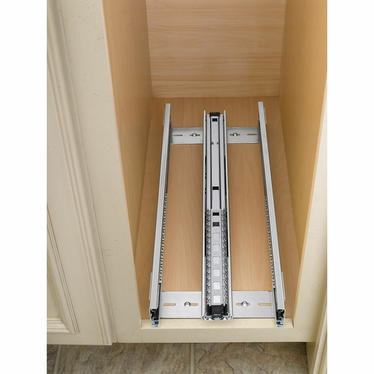 an open drawer with two sliding doors on the bottom and one in the lower half