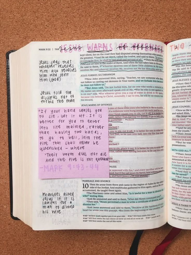 an open bible with sticky notes attached to it