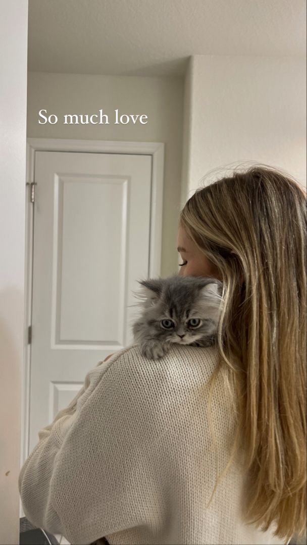 a woman holding a cat in her arms with the caption, so much love