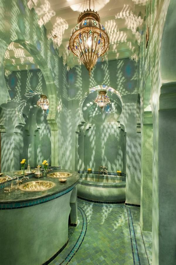 a bathroom with two sinks and a chandelier hanging from it's ceiling