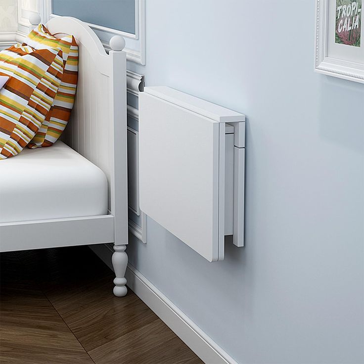 a white chair with a pillow on top of it next to a radiator