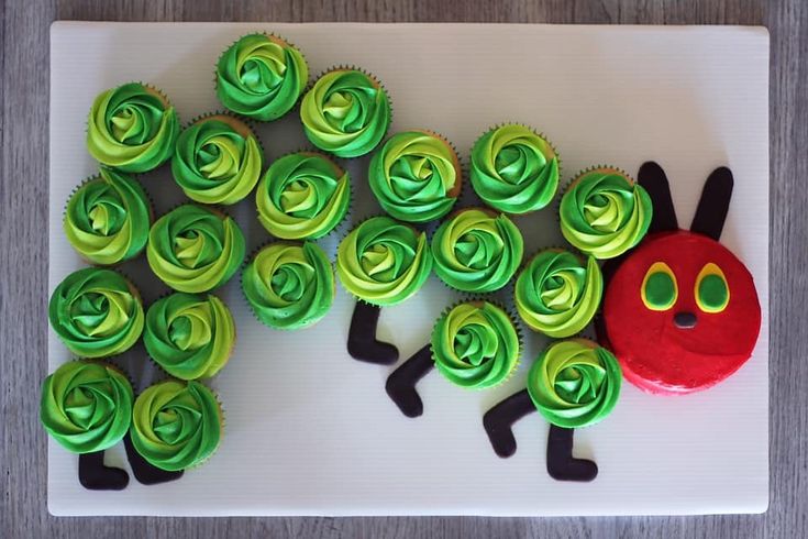 cupcakes with green and blue frosting shaped like a caterpillar