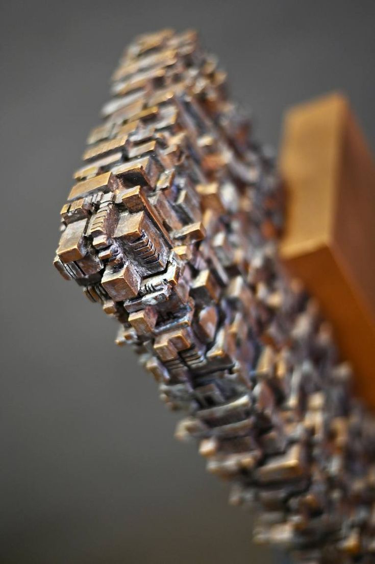 a close up view of a wooden object with many small objects on it's sides