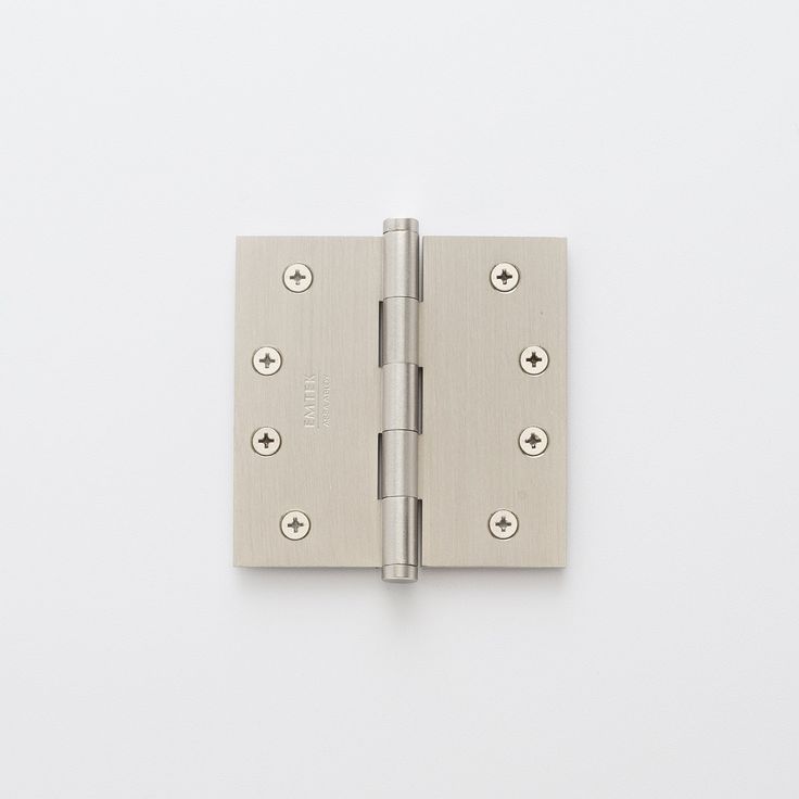 a brass plated door hinge with four screws on the front and side