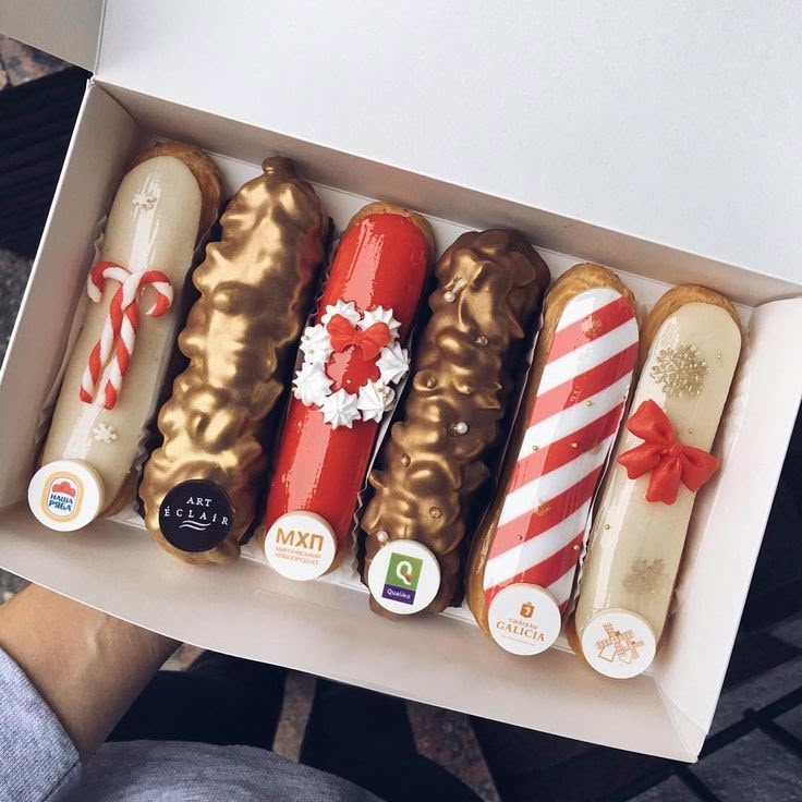 a box filled with assorted donuts and candy canes on top of each other