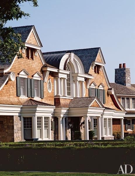 a large brown and white house with lots of windows