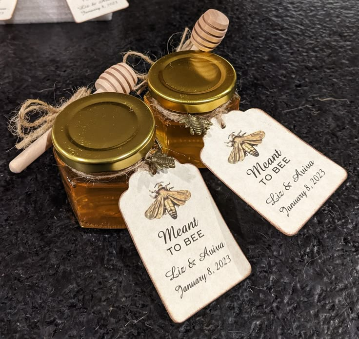 three honey jars with labels on them sitting on a counter