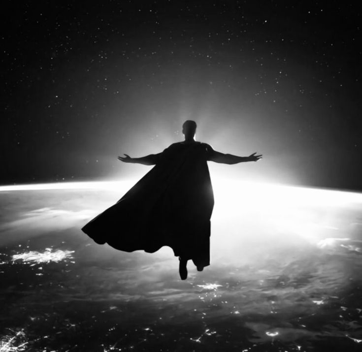 a man in a long dress is flying over the earth with his arms spread out