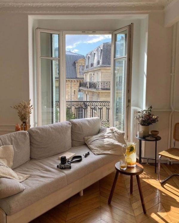 a living room filled with furniture and windows