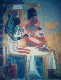 an egyptian painting with two people sitting on it