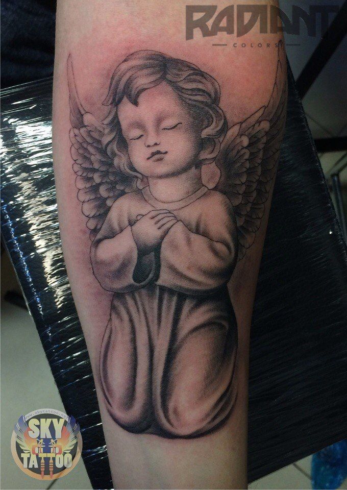 an angel tattoo is shown on the leg