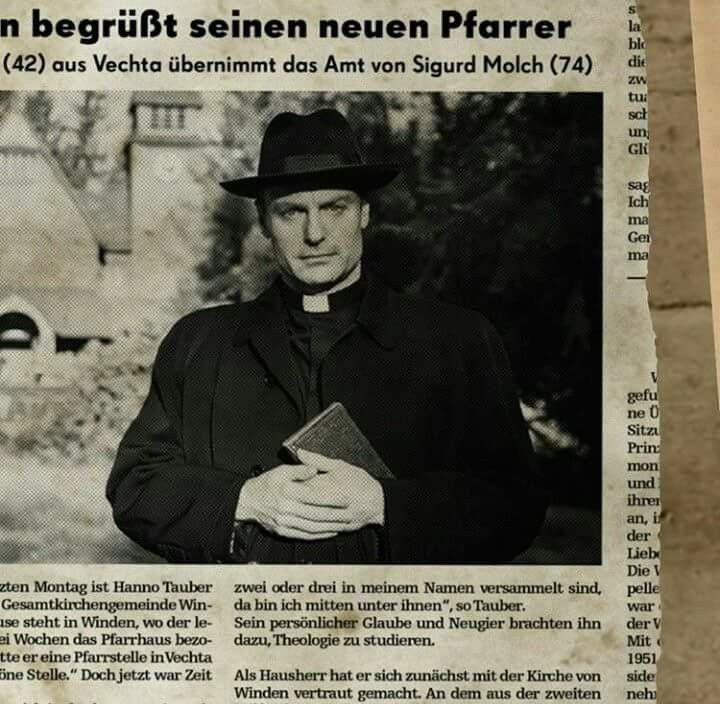 an old newspaper article with a man in a black hat and coat holding a book