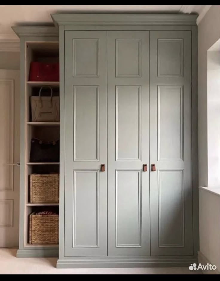 an empty room with some white cabinets and baskets