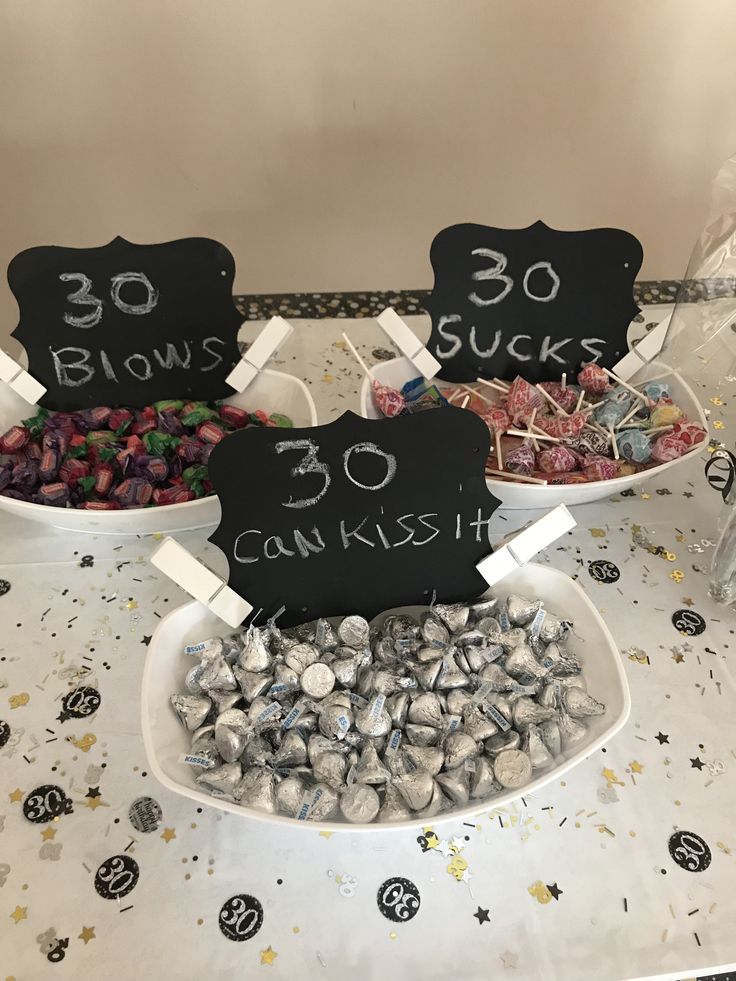 two bowls filled with candies on top of a table next to other candy items