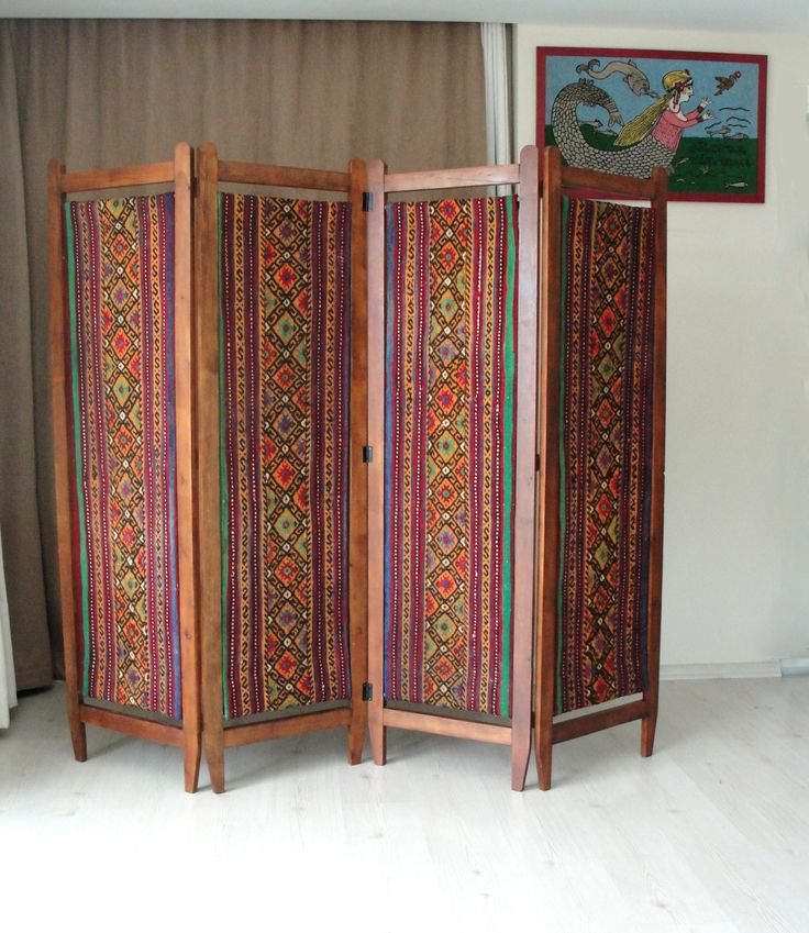 This gorgeous colorful bohemian upholstered wooden room divider would look great anywhere in your living room, office or bedroom. It is entirely made of solid cherry wood and is made in the 1920s or 1930s. PLEASE CONTACT US WITH YOUR LOCATION FOR AN EXACT SHIPPING QUOTE! It has been entirely sanded, stained and oiled. The original fabric was beyond redemption so we replaced it with vintage kilim. Making it a bold, rich, and statement piece of furniture. It would look great in the middle of a roo Room Divider Inspiration, 1920s Room, Office In Home, Fabric Room Divider, Vintage Room Divider, Room Divider Shelves, Hippie House, Screen Divider, Geometric Furniture