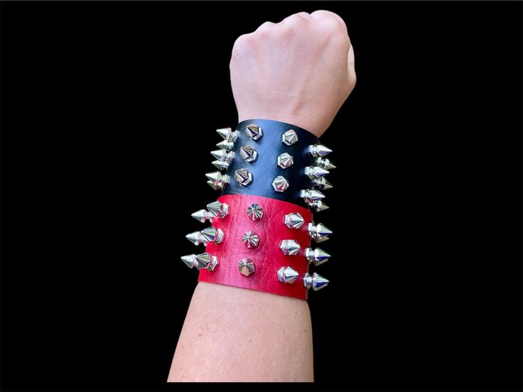 These rivet cone stud spiked cuff bracelet is made with PU leather, and 3 rows of riveted acrylic spikes with snap closure  comes in black or red, pick your color and amount  at checkout  For more colors click here https://www.etsy.com/listing/985108865/rivet-cone-stud-cuff-gothic-bracelet Fashionable, Vegan Friendly, Adjustable  Snap closure fits up 7- 8" wrists comfortably  For smaller wrists and youth sizes, custom sizing for wrists sizes smaller than 7", BLACK ONLY click this listing link ⬇️ Spiked Cuff Bracelet, Spike Wristband, Adjustable Spiked Punk Wristband, Spikes Bracelet, Stud Bracelet Spikes, Spike Bracelet, Gothic Bracelet, Black Only, Vegan Friendly