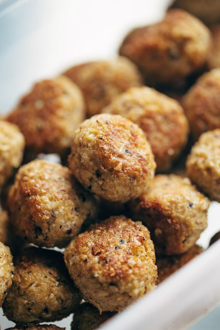 some meatballs are sitting in a white bowl