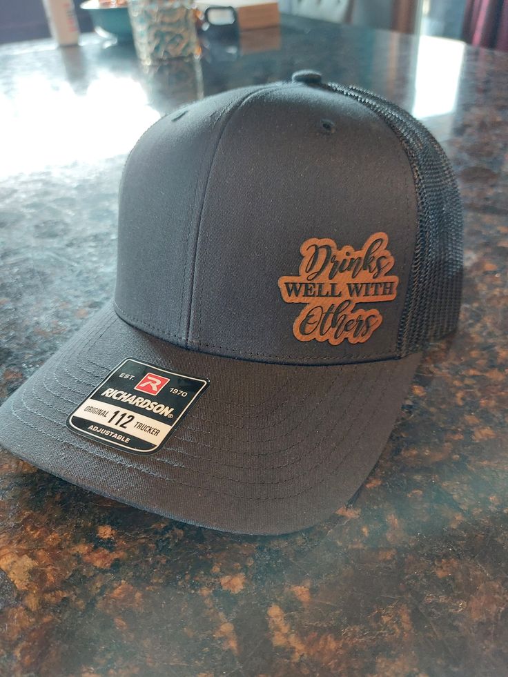 Totally Custom Leather Patch Hats,  Either the Richardson Snap Back hat, or the Flex Fit Fitted Hat.   Other colors available, and more on the way soon.   Any logo, saying or design that you want,  Just message me to get started. Large quantity orders are welcome,  message me for a quote. Trucker Hat With Curved Brim And Custom Logo, Brown Curved Bill Hat With Letter Print, Trucker Hat With Custom Logo And Curved Brim, Trucker Hat With Letter Patch And Flat Brim, Customizable Brown Hat With Flat Brim, Brown Curved Brim Hat With Letter Patch, Customizable Brown Snapback Hat With Flat Brim, Brown Curved Bill Hat With Letter Patch, Customizable Brown Flat Brim Hat