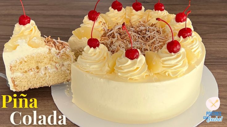 a cake with white frosting and pineapple toppings next to a piece of cake on a plate