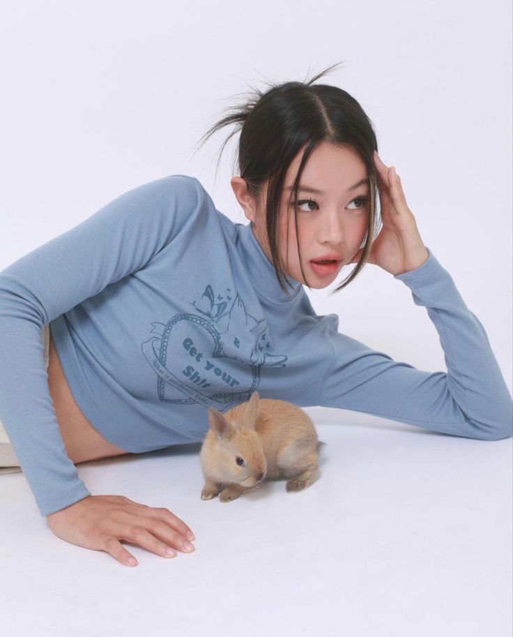 a woman laying on the floor with a hamster