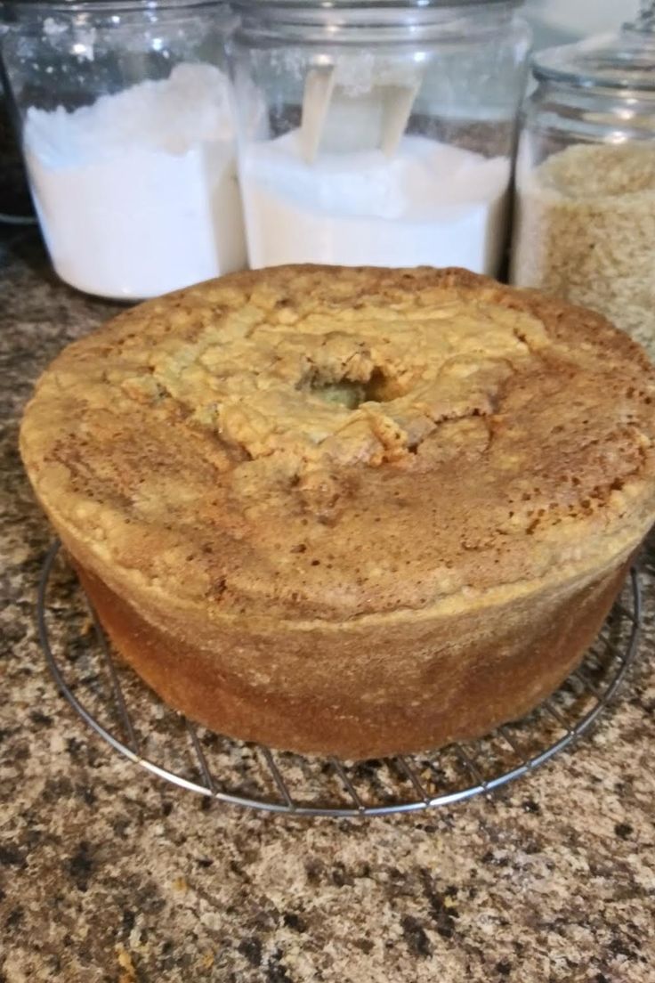 a cake sitting on top of a metal rack next to some milk and other food