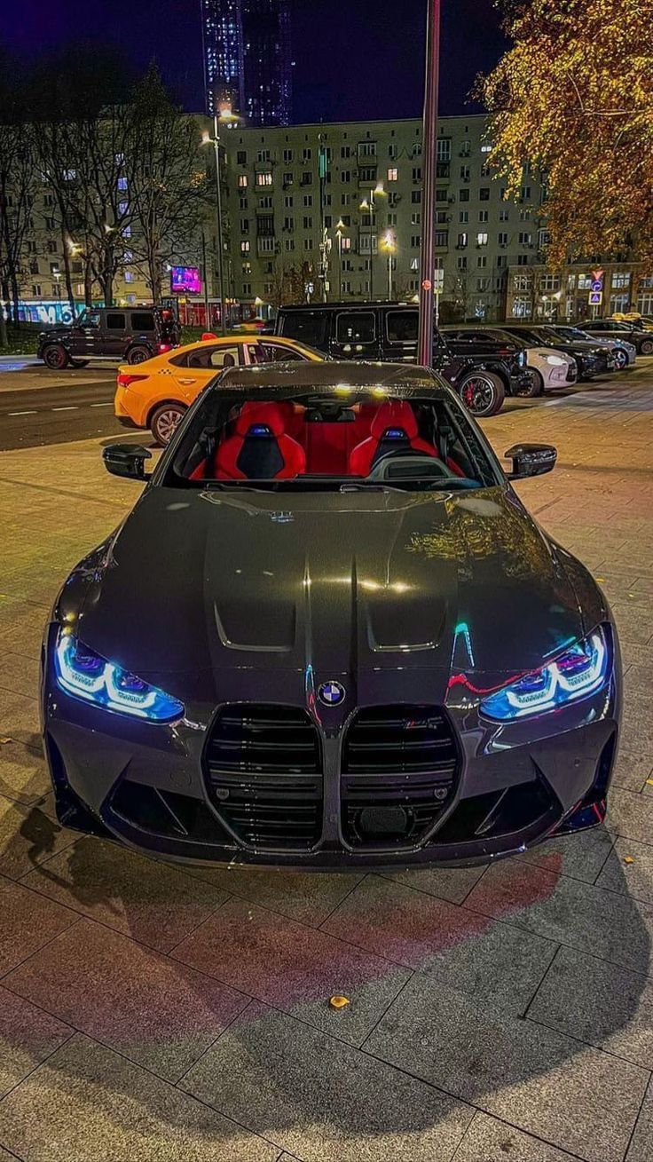 a black sports car parked on the street at night