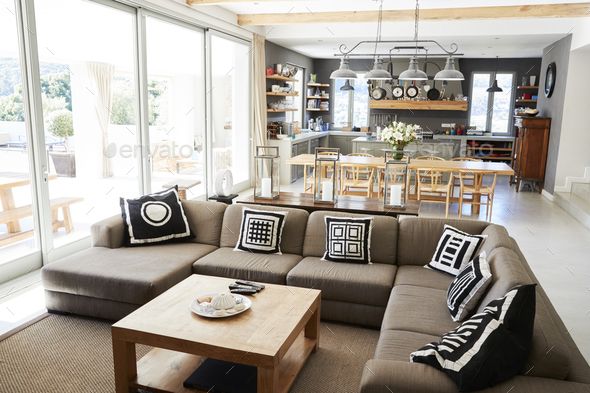 a living room filled with furniture and lots of windows