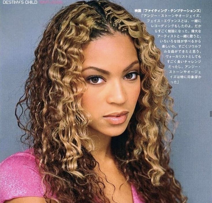 a woman with long curly hair is posing for a magazine advertiser's photo