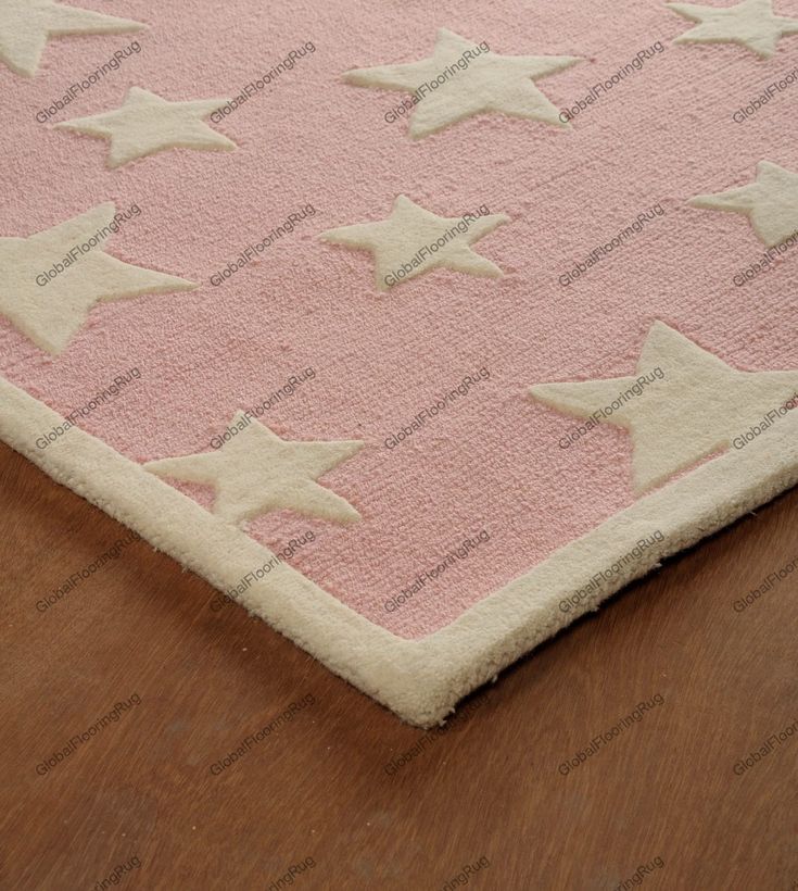 a pink rug with white stars on it