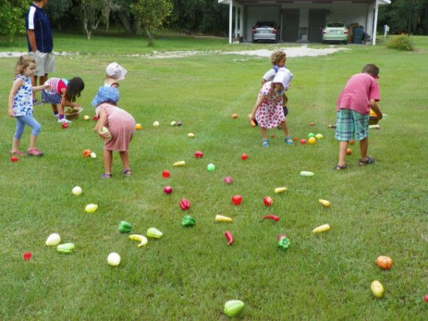 children playing with plastic eggs in the yard