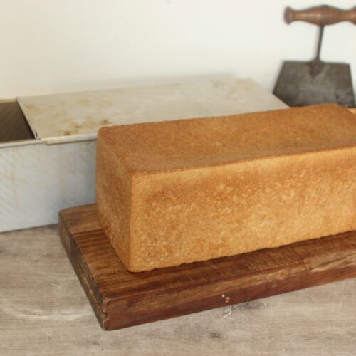 a block of bread sitting on top of a wooden board