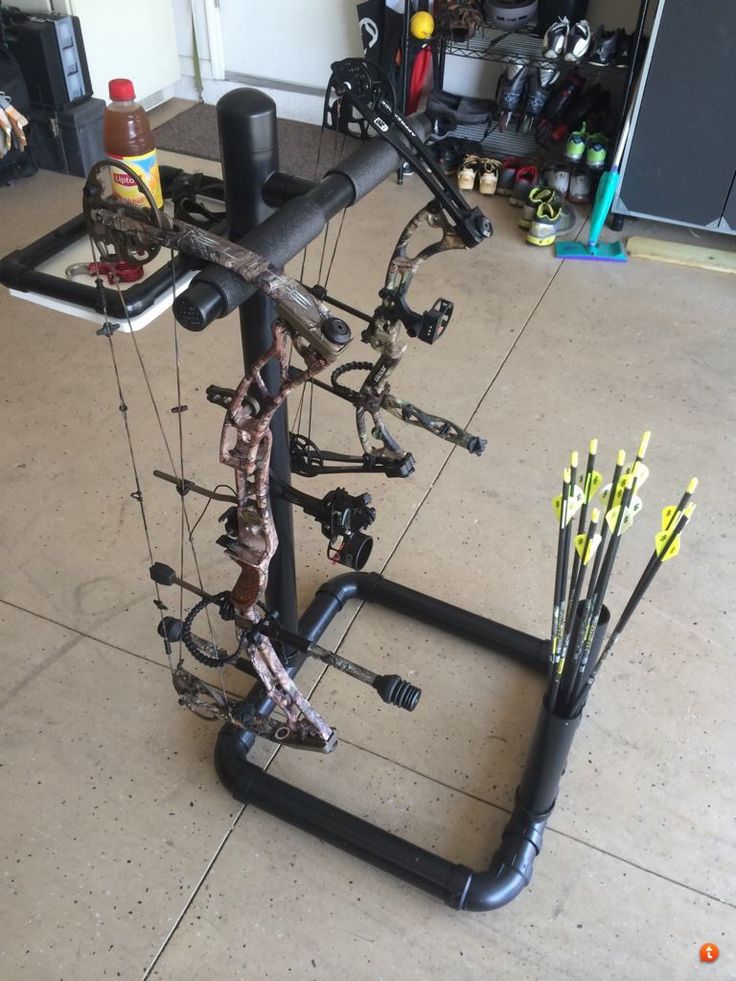 the bow rack has many arrows attached to it