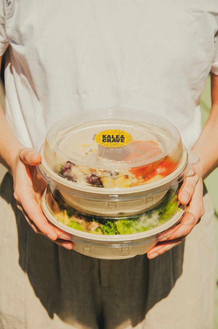 a person holding a plate with food in it