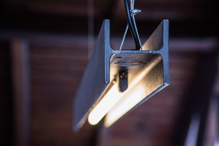 an industrial light fixture hanging from the ceiling