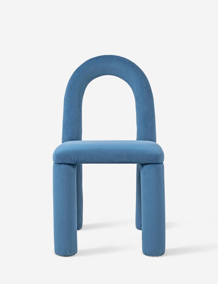 a blue chair sitting on top of a white floor next to a black object with an arch in the middle