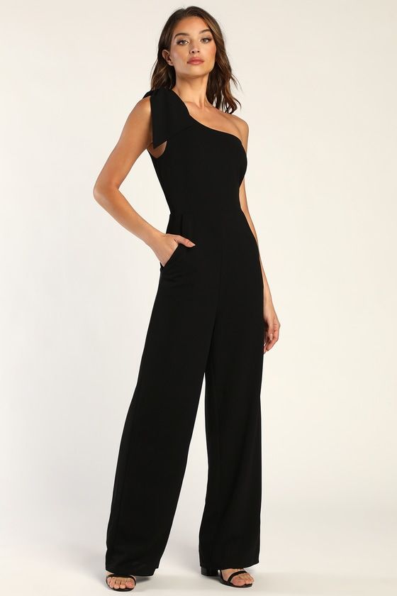 Any day you wear the Lulus Loveliest Style Black One-Shoulder Wide-Leg Jumpsuit will be a special day to remember! Stretchy techno crepe knit shapes this event-ready jumpsuit that boasts a darted bodice and a one-shoulder neckline (with hidden no-slip strips), supported by a wide tank strap adorned with an oversized decorative bow. A high, fitted waist tops wide pant legs feature diagonal front pockets before falling to ankle-grazing hems. Hidden side zipper/clasp. Black Jumpsuit Outfit Night, Wide Leg Black Pants Outfit, Black Jumper Outfit, Black Dressy Jumpsuit, Graduation Outfits For Women, Colored Pants Outfits, Cocktail Wedding Attire, Black Jumpsuit Outfit, Wedding Guest Outfit Ideas