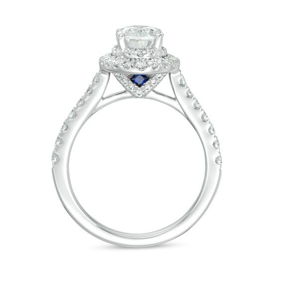 a diamond and blue sapphire engagement ring on a white background with the center stone surrounded by diamonds