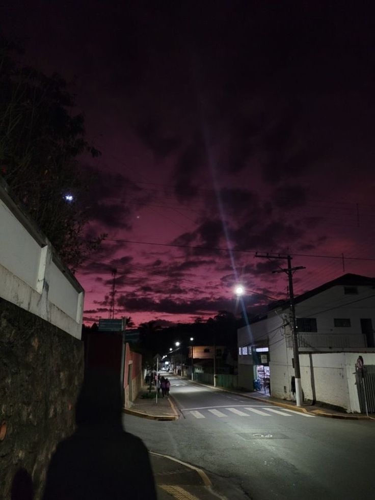 a person standing on the side of a road at night