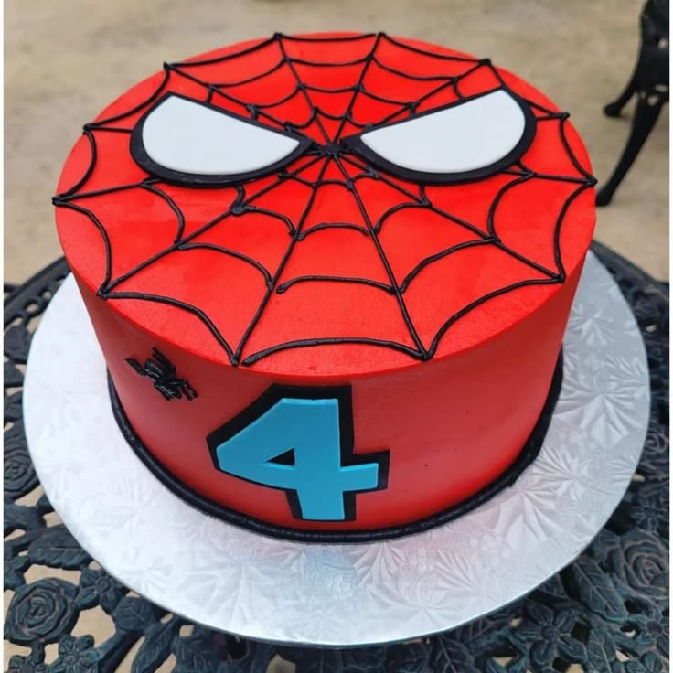 a spiderman birthday cake with the number four on it's face and eyes