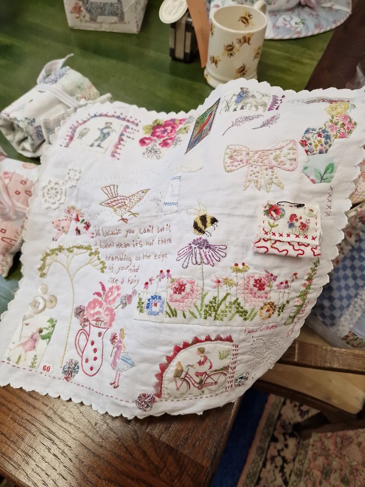 a table topped with lots of different types of cloths on top of a wooden table