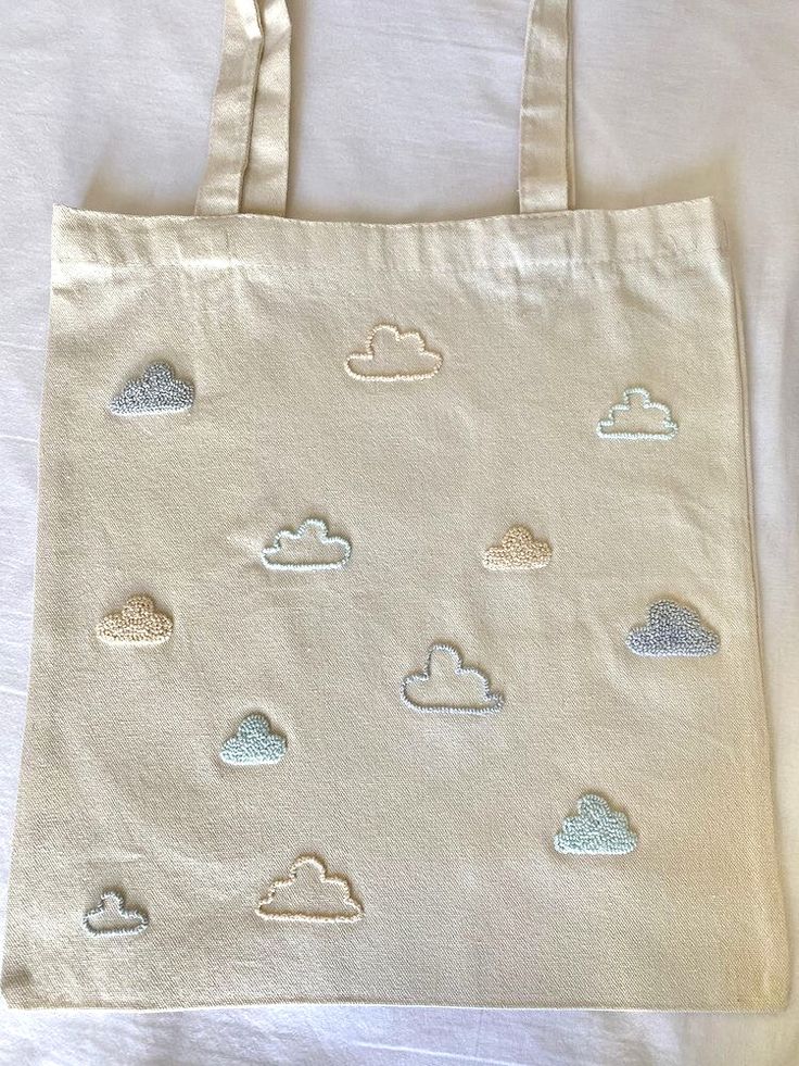 a tote bag with clouds drawn on it